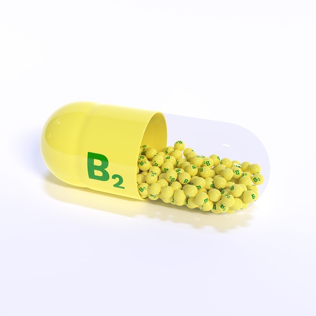 Vitamine B2 avec des granulés de capsules jaunes et un fond blanc