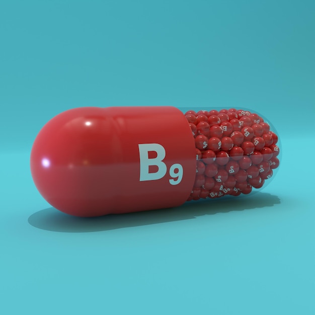 Photo vitamine b9 avec des granulés de capsules rouges et un fond turquoise