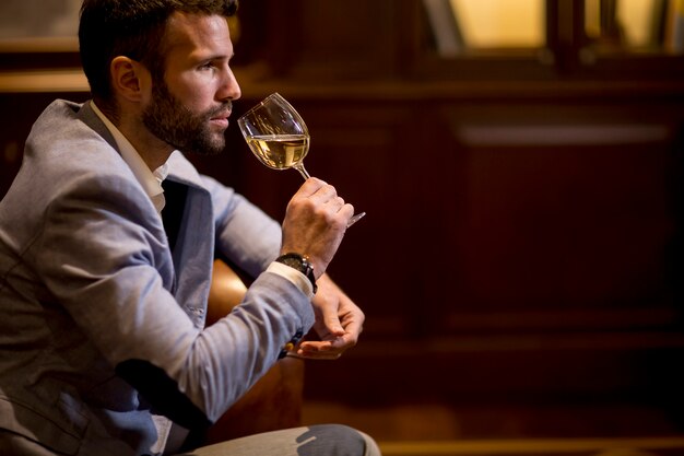 Voir au jeune homme dégustation de vin blanc