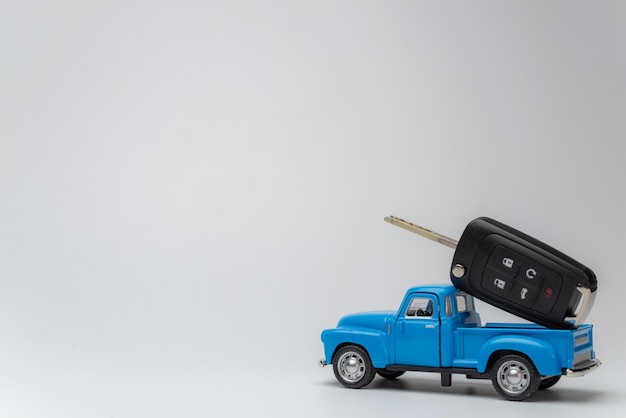 Photo une voiture de jouet avec des clés sur fond blanc