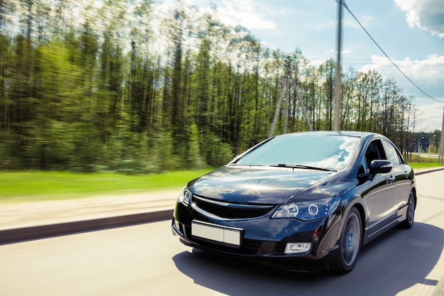 Voiture noire roule sur la route en mouvement