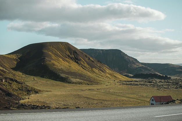 Une voiture sur la route avec des montagnes en arrière-plan