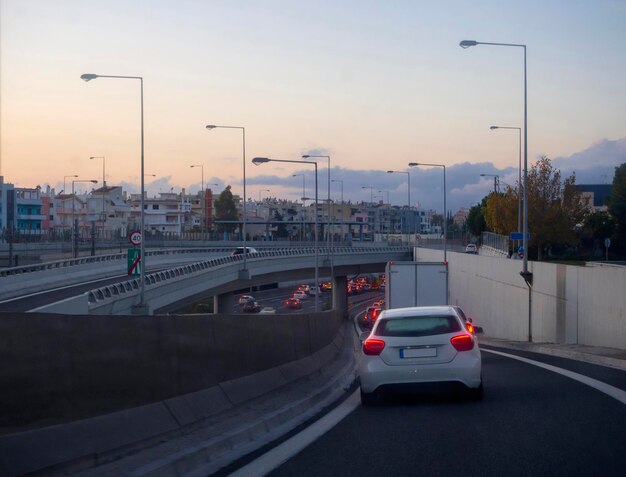 Les voitures roulent sur l'autoroute à Athènes Grèce un soir d'hiver au coucher du soleil