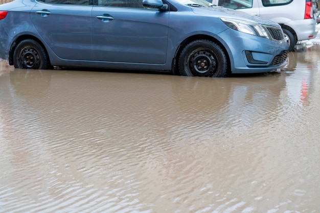 Les voitures se déplacent dans la route de l'eau, catastrophe d'inondation dehors