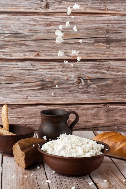 Voler du fromage cottage frais dans un bol en bois, pot de crème sure sur un bois