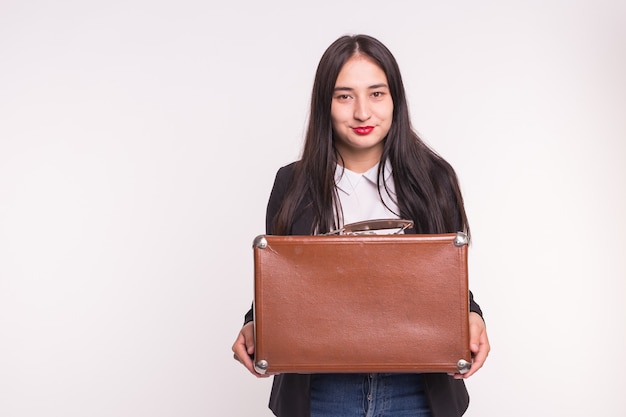 Voyage de valise et concept de personnes femme asiatique tenant vieille valise brune sur une surface blanche avec