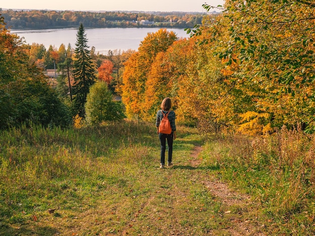 Voyageur de femme randonnée avec sac à dos à la colline d'automne. Voyage aventure concept de style de vie vacances en plein air.