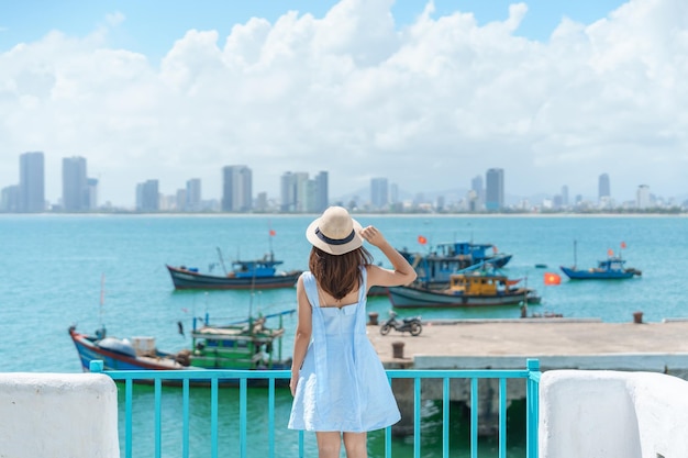 Voyageur femme visitant la marina de Son Tra Touriste avec robe bleue et chapeau voyageant dans la ville de Da Nang Concept de voyage au Vietnam et en Asie du Sud-Est