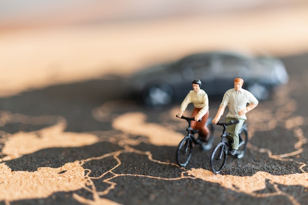 Voyageurs de personnes miniatures à vélo