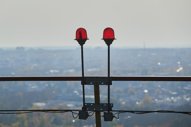 Voyant d'avertissement rouge avec la lumière allumée contre le ciel bleu de la zone de l'usine explosive feux rouges sur le toit d'un immeuble de grande hauteur pour la sécurité des bâtiments et du transport aérien pour le concept de sécurité