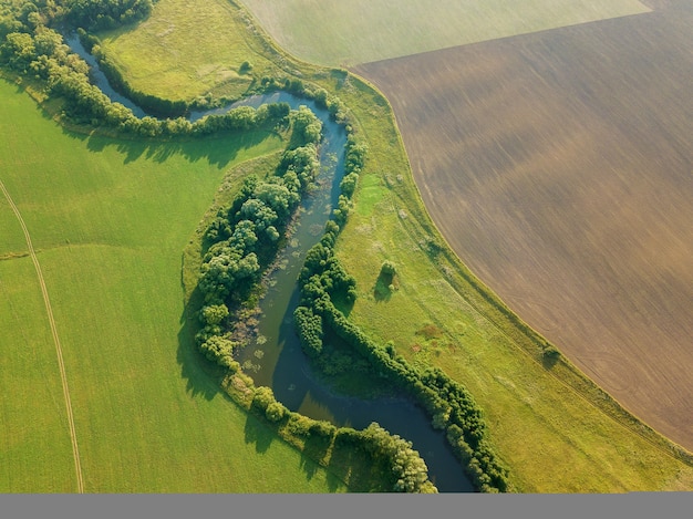 Vue aérienne de drone de la rivière parmi les champs la bande médiane de la russie