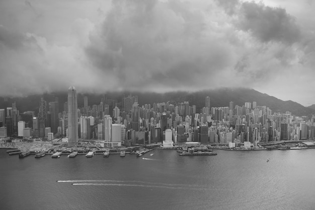 Vue aérienne du port de Victoria et horizon à Hong Kong avec des gratte-ciel urbains en noir et blanc.