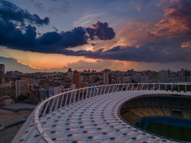 Vue aérienne du stade de football de la ville sur fond de coucher de soleil et de beaux nuages