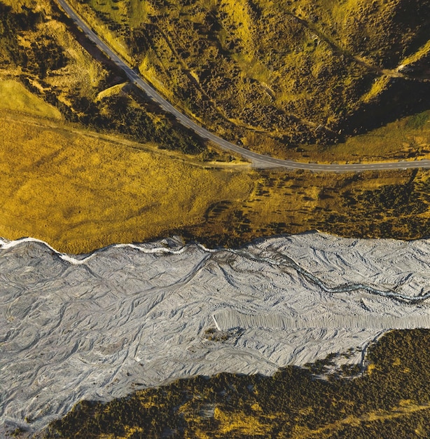 Photo vue aérienne de haut de drone d'un ruisseau de roche et de gravier sur le côté d'une autoroute