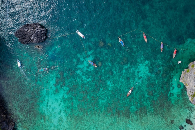 Vue aérienne de l&#39;île phi phi en haute saison, les touristes thaïlandais et étrangers font de la plongée avec tuba en louant un bateau à longue queue et un bateau rapide pour les voyages