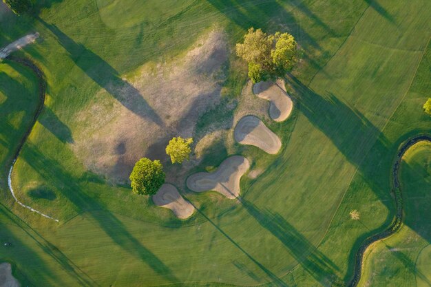 Photo vue aérienne d'un parcours de golf vert au coucher du soleil