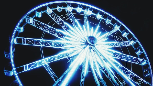 Photo vue d'angle bas de la roue de ferris éclairée la nuit