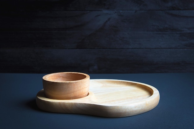 Photo vue d'angle élevé d'une plaque et d'un bol en bois sur la table