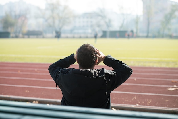 Vue arrière du jeune homme crie Benching