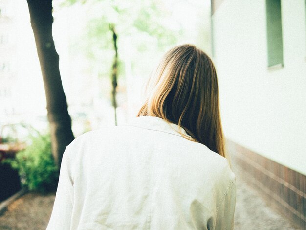 Photo vue arrière d'une femme marchant dans la rue