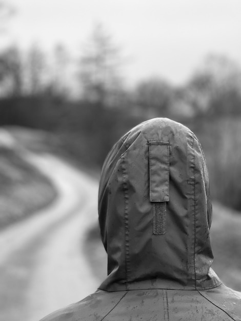 Photo vue arrière d'une femme marchant sur une route de campagne