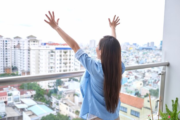 Vue Arrière D'une Femme Sportive Active Qui S'étend Sur Un Balcon