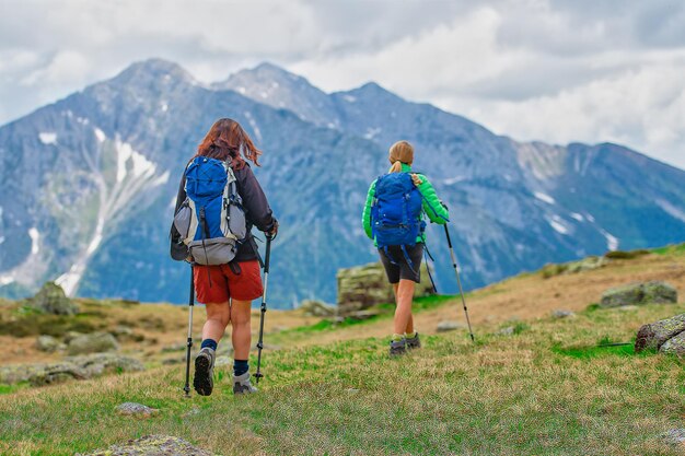 Vue arrière des gens et des montagnes contre le ciel