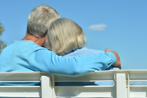 Vue arrière Heureux couple de personnes âgées assis sur un banc