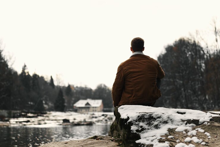 Photo vue arrière d'un homme regardant le lac contre le ciel