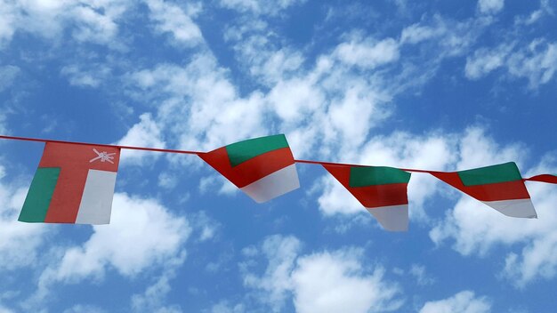 Vue à bas angle des drapeaux d'Oman suspendus contre le ciel