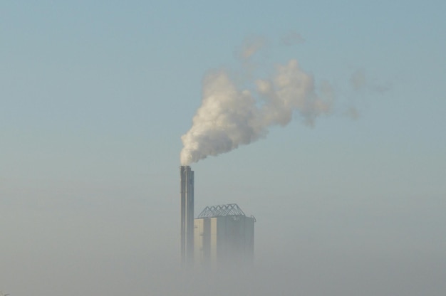 Photo vue à bas angle de la fumée provenant de l'industrie contre le ciel