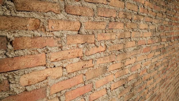 Photo vue de côté de vieux fond de mur de brique vintage orange