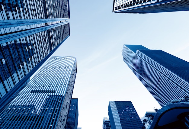 Vue de dessous des gratte-ciel modernes dans le quartier des affaires contre le ciel bleu