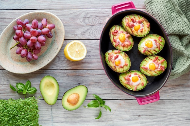 Vue de dessus sur les bateaux d'avocat grillés avec bacon et œufs de caille