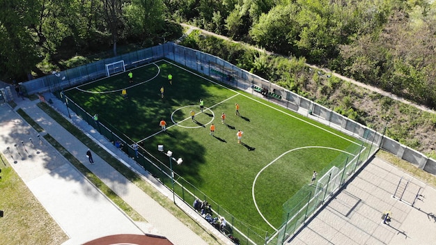 Vue de dessus de drone aérien du mini terrain de football avec des gens qui jouent.