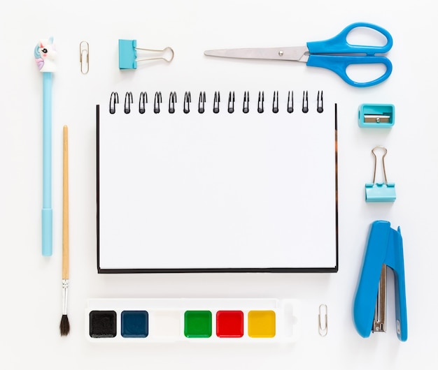 vue de dessus du bureau bleu blanc moderne avec fournitures scolaires et papeterie