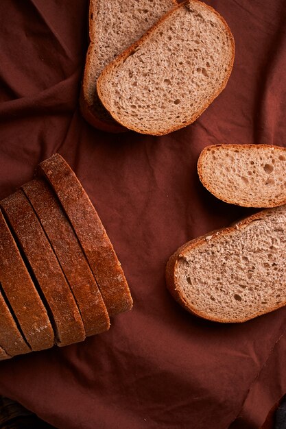 Vue de dessus du pain de grains entiers en tranches sur bois rustique foncé