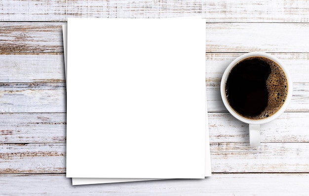 Vue de dessus avec du papier blanc et du café sur fond de table en bois