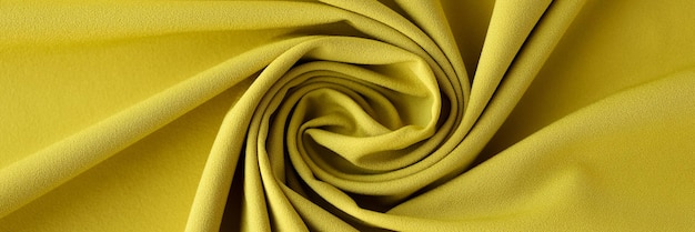 Vue de dessus du tissu d'olive fond texturé tissu texture toile de fond tissu jaune ondulé mutilé