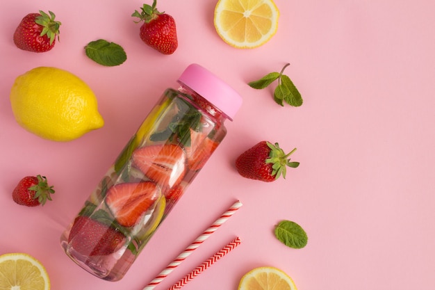 Vue de dessus de l'eau infusée à la fraise et au citron dans la bouteille