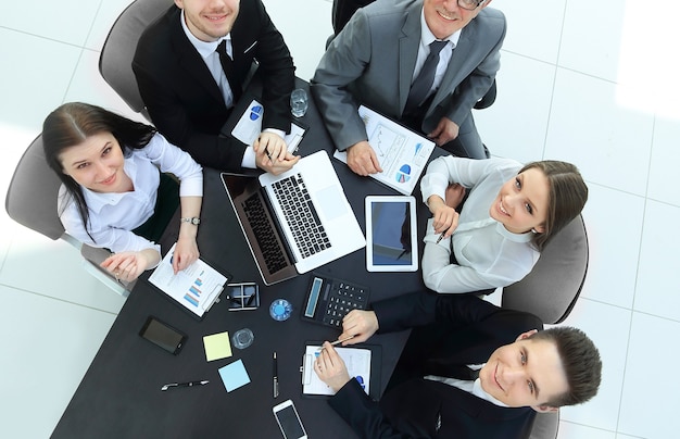 Vue de dessus.équipe commerciale à un bureau en regardant la caméra.le concept de travail d'équipe