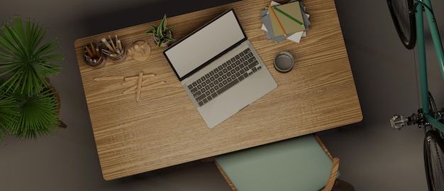 Vue de dessus d'un espace de travail moderne et confortable avec ordinateur portable et fournitures de bureau sur une table en bois