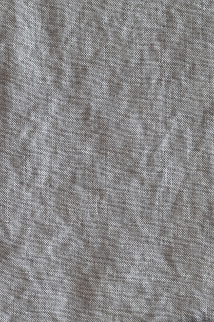 Vue de dessus sur fond de tissu de lin froissé gris. Gros plan de torchon, serviette, nappe ou vêtements.