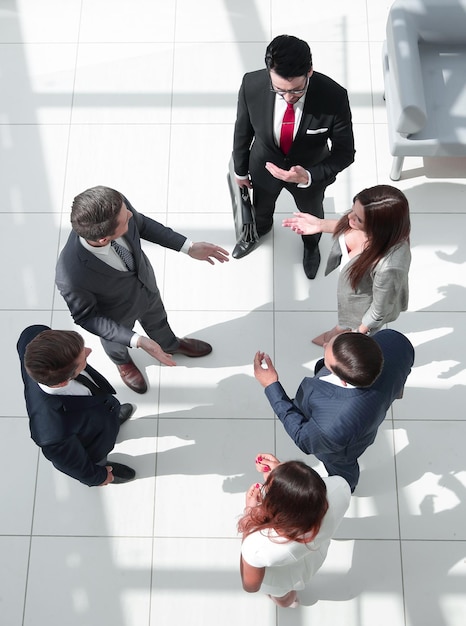 Vue de dessus un groupe de gens d'affaires qui parlent debout dans le hall