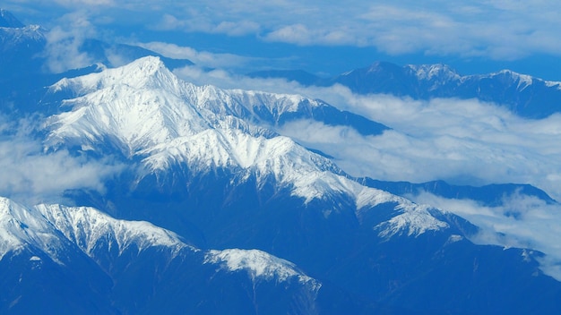 Vue de dessus des images d'angle de collines de neige autour de la montagne Fuji et nuages de lumière blanche et ciel bleu à Tokyo au Japon