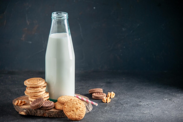 Vue De Dessus D'un Lait Frais Dans Une Bouteille En Verre Biscuits Noix Sur Le Côté Droit Sur Une Surface Noire