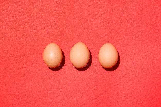 Vue de dessus des oeufs de pâques rouges traditionnels sur fond rouge.