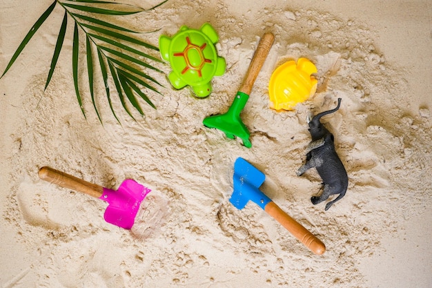 Vue de dessus pelle jouets de plage sur fond de sable fond d'été