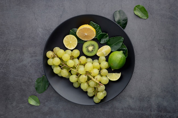 Photo vue de dessus de la plaque avec des raisins et des kiwis