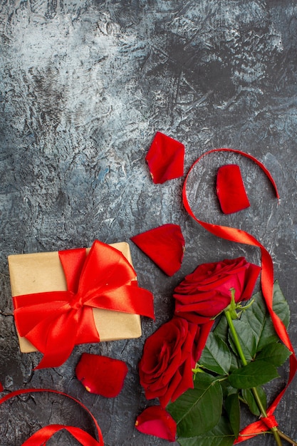 vue de dessus des roses rouges avec des cadeaux pour la saint valentin sur fond gris clair couple mariage coeur amour vacances sentiment